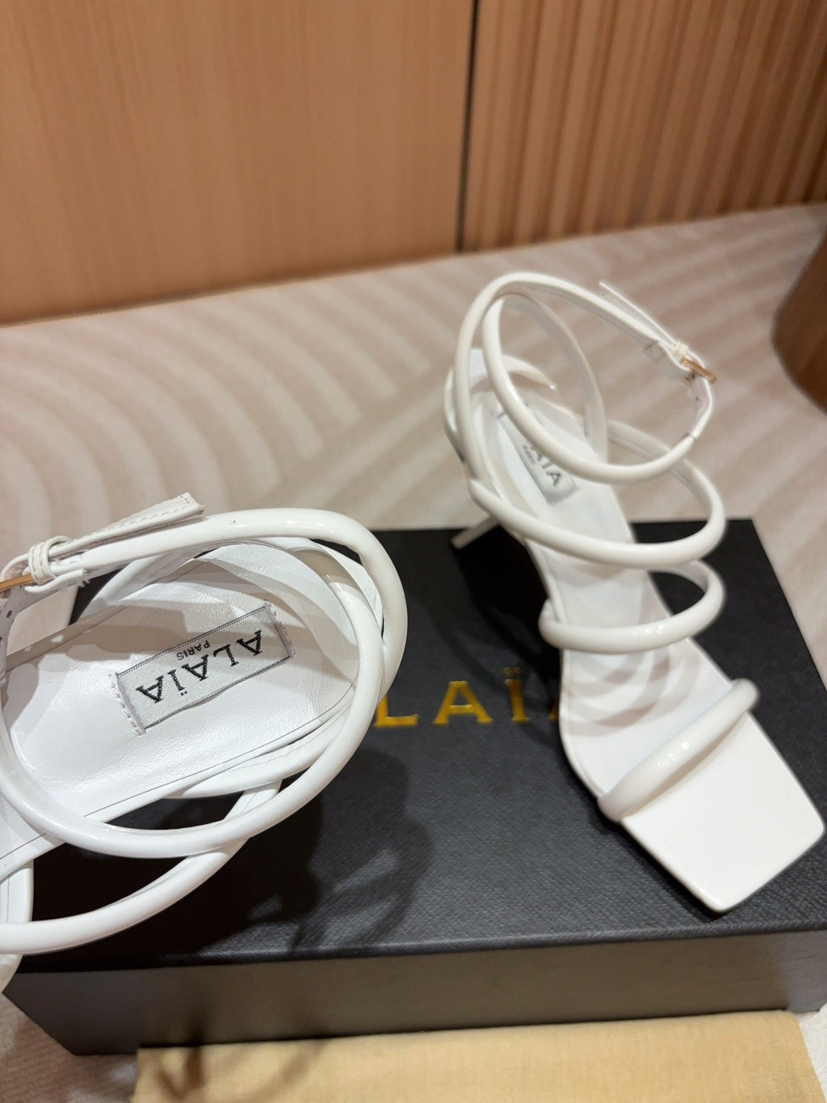 ALAIA THREE-STRAPS HIGH HEEL SANDALS IN WHITE PATENT LAMBSKIN