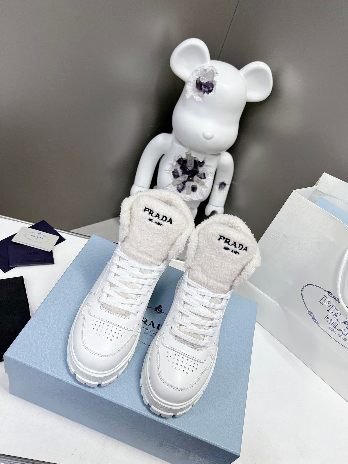 Prada Leather And Shearling High Top  Sneakers
