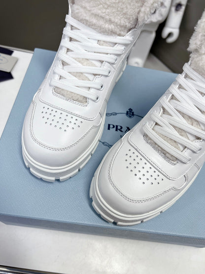 Prada Leather And Shearling High Top  Sneakers