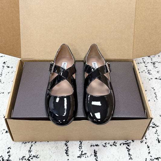 ALAIA 26S CROSS-STRAP BALLET FLATS IN BLACK GLOSSY LAMBSKIN
