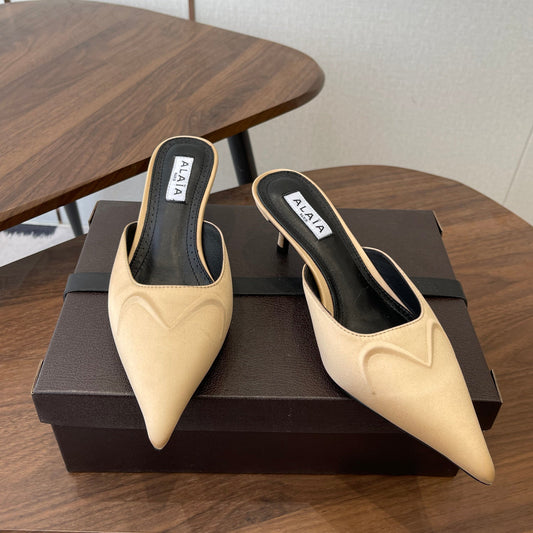 ALAIA 26S HEELED MULES 50 MM IN WARM BEIGE FABRIC