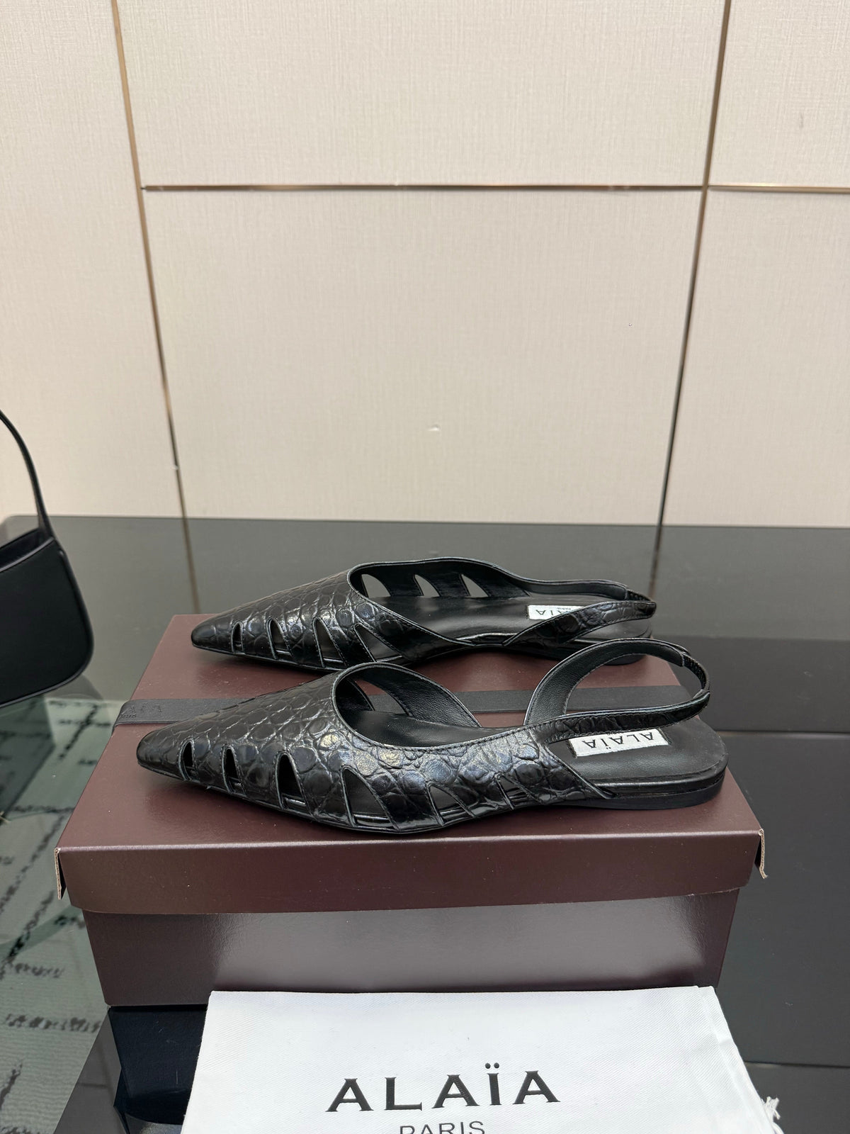ALAIA 26S CUT-OUT SLINGBACK FLATS IN BLACK CROC-EMBOSSED LEATHER