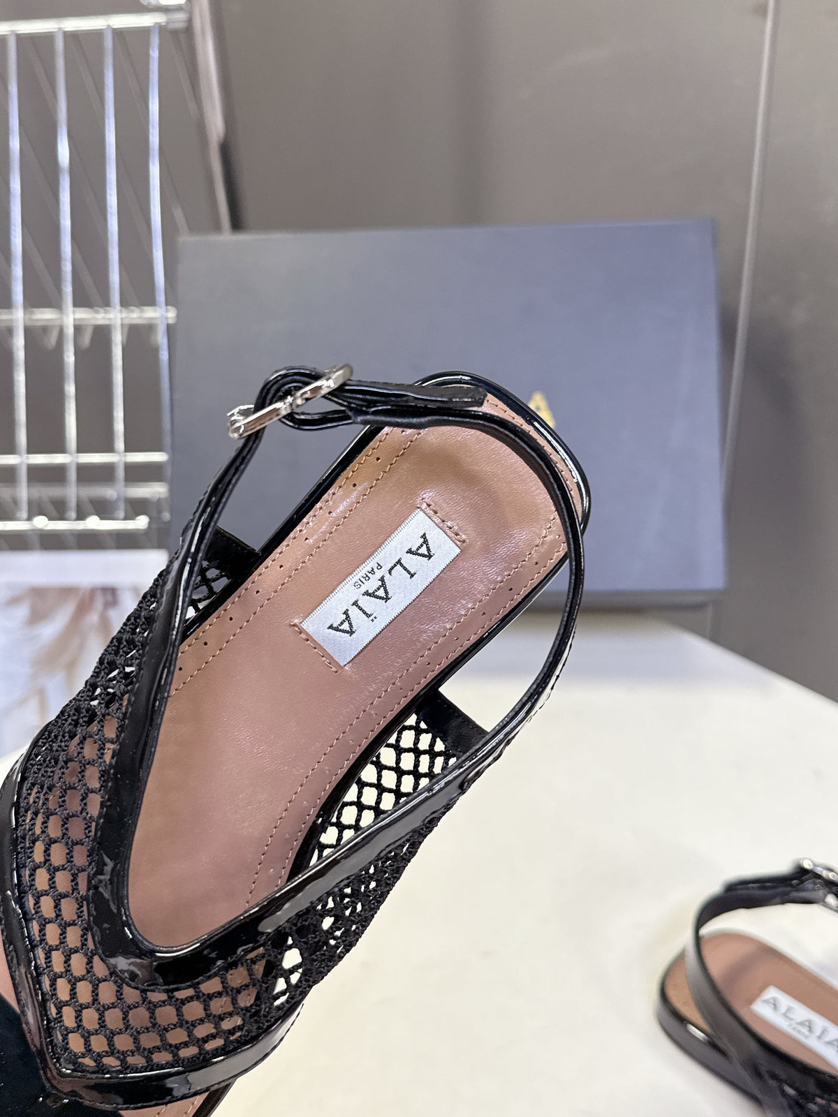 ALAIA 26S FLAT MESH THONG SANDALS IN BLACK PATENT CALFSKIN