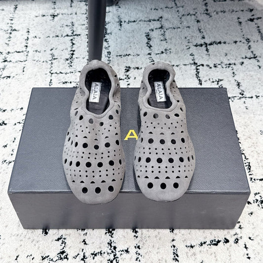 ALAIA 26S FLAT SLIP-ONS IN GREY SUEDE WITH OPENWORK PATTERN