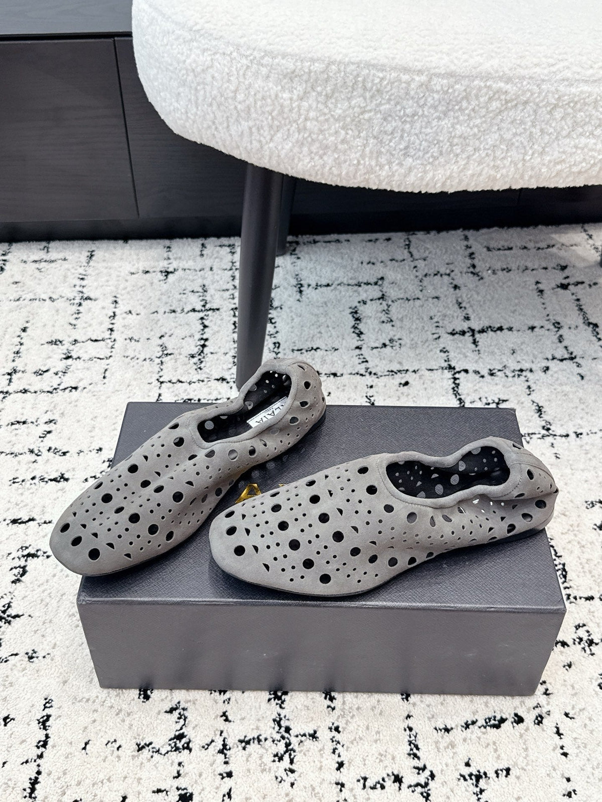ALAIA 26S FLAT SLIP-ONS IN GREY SUEDE WITH OPENWORK PATTERN