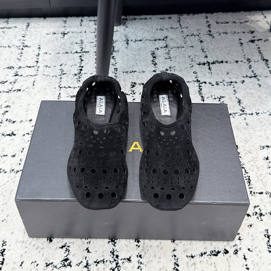 ALAIA 26S FLAT SLIP-ONS IN BLACK SUEDE WITH OPENWORK PATTERN