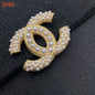Studded letter tassel brooch